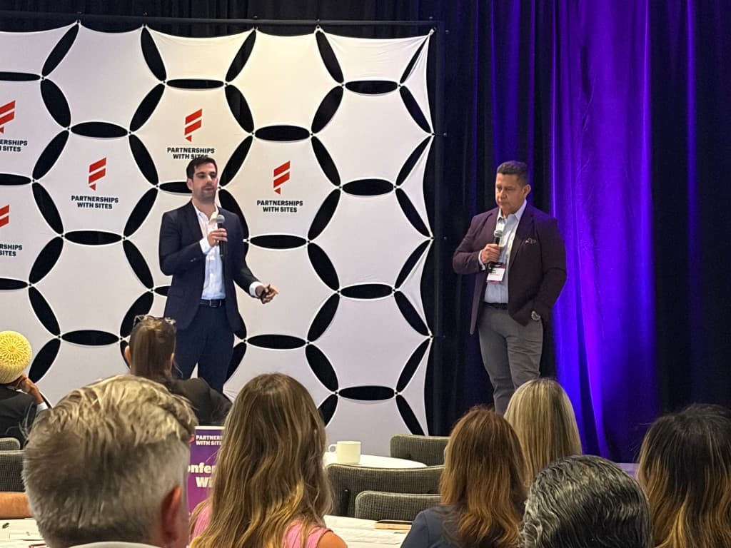 Stitch team presenting on stage at a Partnerships with Sites conference