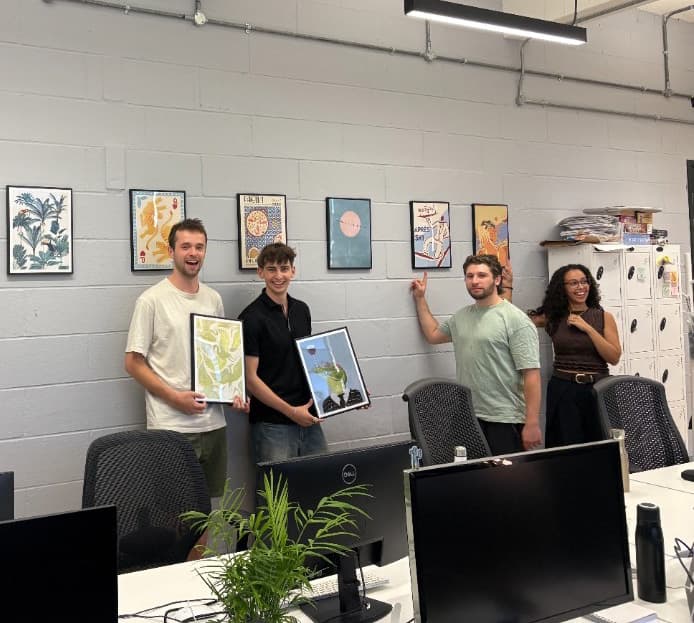 Stitch team celebrating new artwork in the office