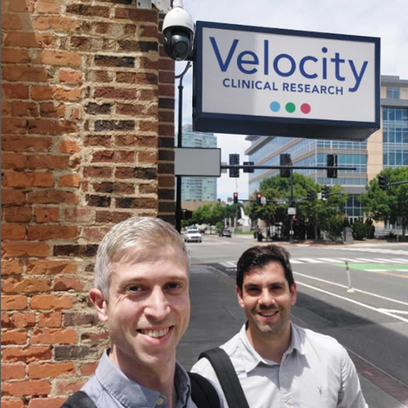 Two members of the Stitch team outside Velocity Clinical Research